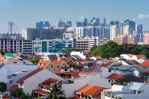 Houses, public HDB apartment blocks and office buildings before the Singapore skyline.