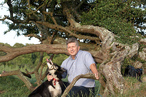istock Mature man in the countryside with border collie 135787680