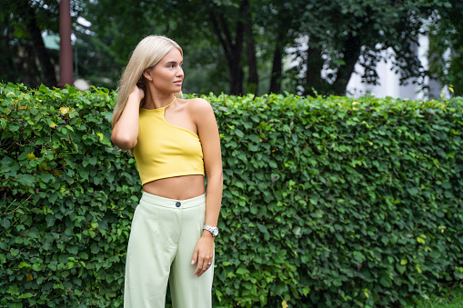 Portrait of beautiful caucasian woman with charming smile walking outdoors.