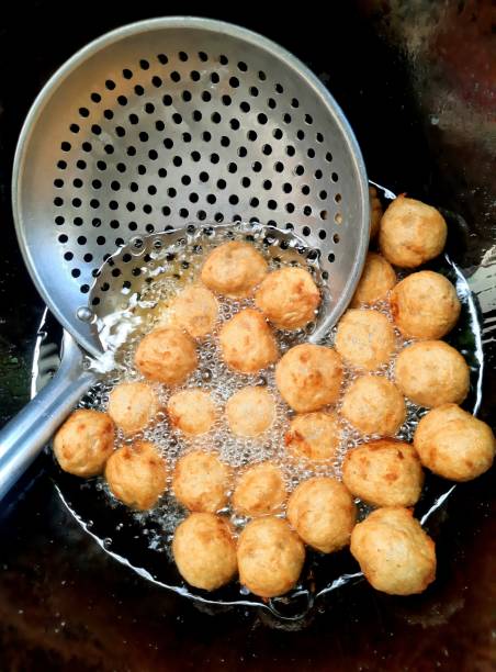 Frying Shrimp meat balls in cooking pan - food preparation. stock photo