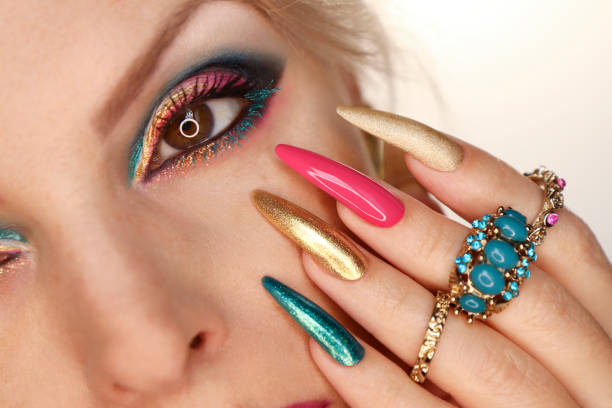 istock A model with pink turquoise makeup and nail design. 1357878233