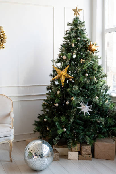 istock Christmas tree with presents and lights in light and airy living room 1357878310