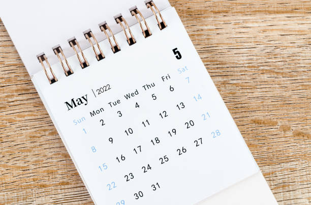 istock May 2022 desk calendar on wooden table. 1357878329