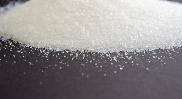 istock sugar on a black background. sugar crystals close up. Black background. granulated sugar. 1357878400