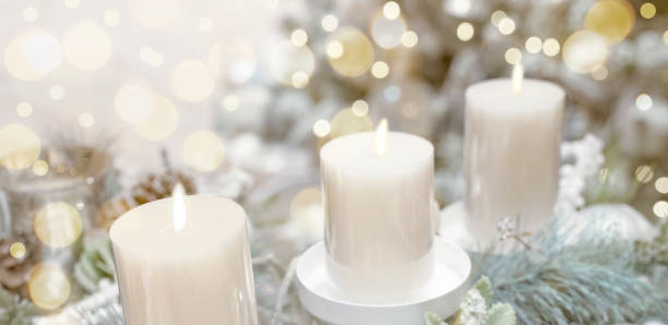 istock Candles burn with fire. Christmas or New Year festive background, Soft selective focus. Decor design element. 1357880009