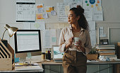 istock Shot of an attractive young businesswoman standing and looking contemplative while holding a cup of coffee in her home office 1357880802