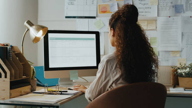 istock Shot of an unrecognisable businesswoman sitting alone and using her computer while working from home 1357880899