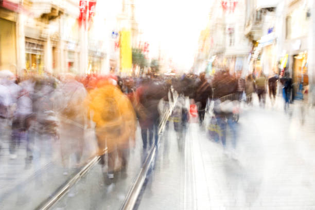 istock Crowd on blur street in bright lens flare 1357881803