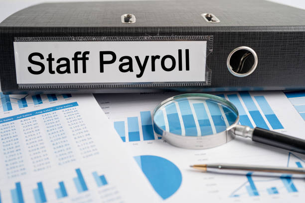 Staff Payroll. Binder data finance report business with graph analysis in office. stock photo