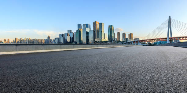Panoramic skyline and modern commercial office buildings with empty road