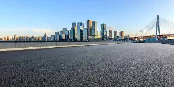Panoramic skyline and modern commercial office buildings with empty road stock photo