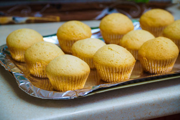 istock Cool freshly baked vanilla muffins on a metal sheet. 1357883214