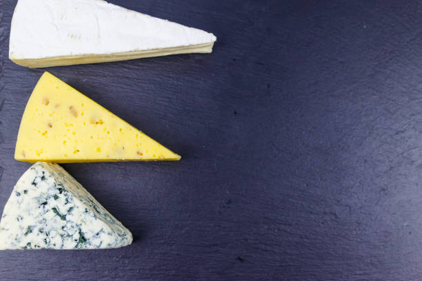 istock Set of various types of cheese on black slate background. Top view 1357883630