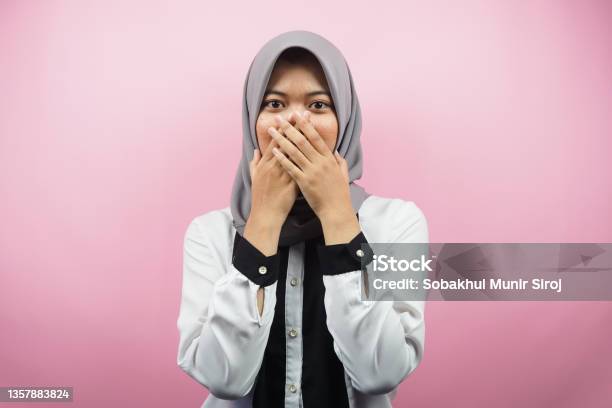 Beautiful Young Asian Muslim Woman Shocked Surprised Disbelieving Getting Shocking Information With Hands Covering Mouth Isolated On Pink Background Stock Photo - Download Image Now