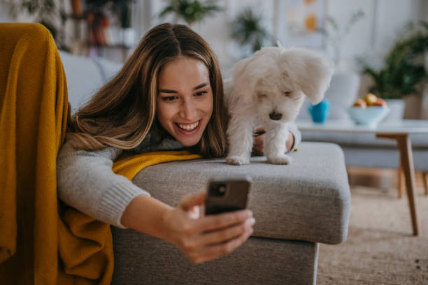 istock Woman relaxing with pet dog 1357885200
