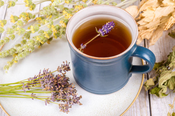 istock Green tea or herbal tea with cup, sugar and dry herbs - lavender tea 1357885218