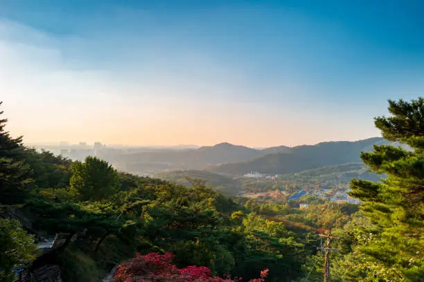 Seoul city at sunset from Yongamsa Temple in Bukhansan National Park in autumn, Seoul, South Korea.