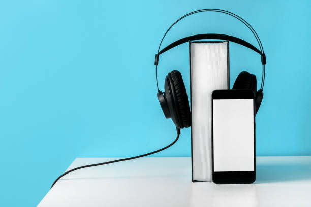 istock Headphones on book. Audiobook horizontal banner with copyspace. Online education and e-learning concept 1357886142