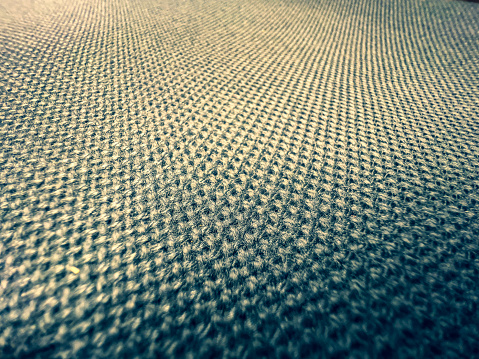 A macro image of a coarse and light fabric.
