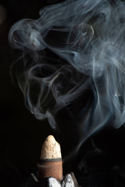 istock incense, incense smoke rising and creating beautiful shapes, Selective focus. 1357887773