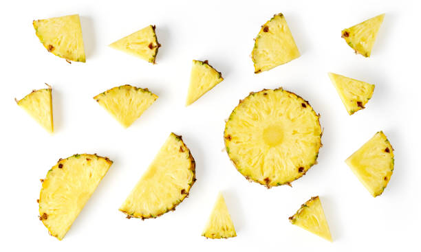 istock Pineapple pieces isolated on white, from above 1357887935