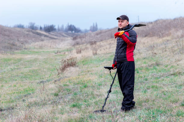istock man with metal detector and shovel 1357888888