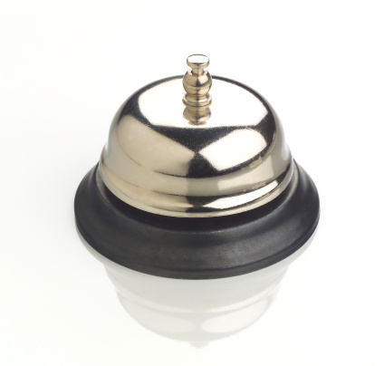 Service bell on white reflective surface