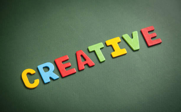 Colorful word Creative on green background.