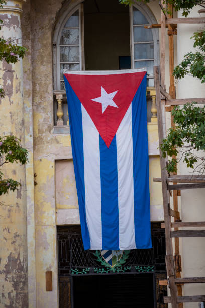 Cuban flag hanging outside a building in Havana, Cuba
