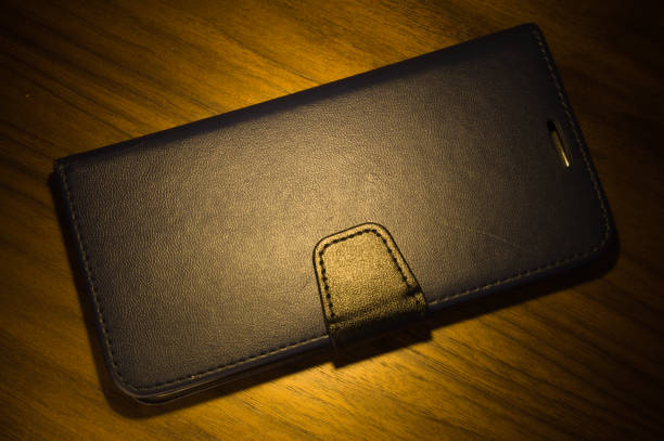 istock Cell phone case made of leather on a table 1357892185