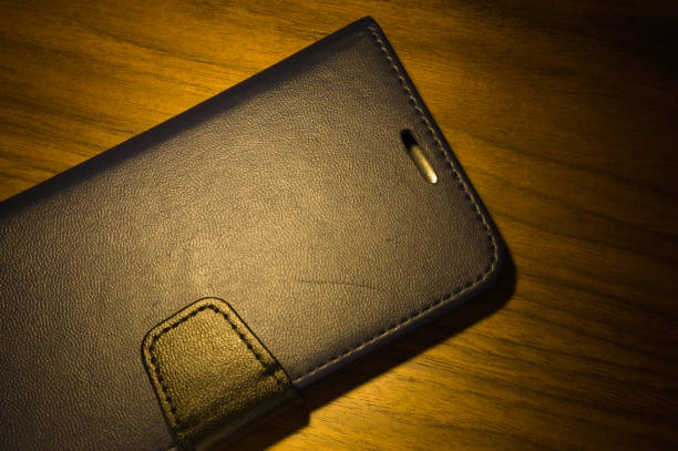 istock Cell phone case made of leather on a table 1357892210