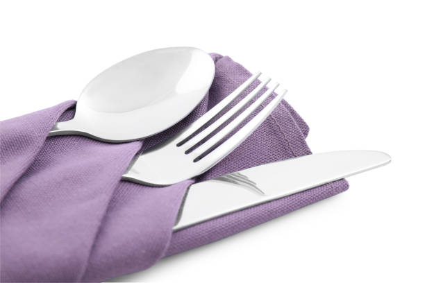 Clean cutlery with napkin isolated on white