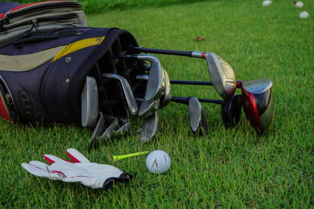 istock Closeup old golf bags on green 1357892309