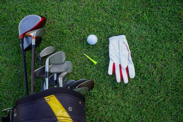 istock Closeup old golf bags on green 1357892315