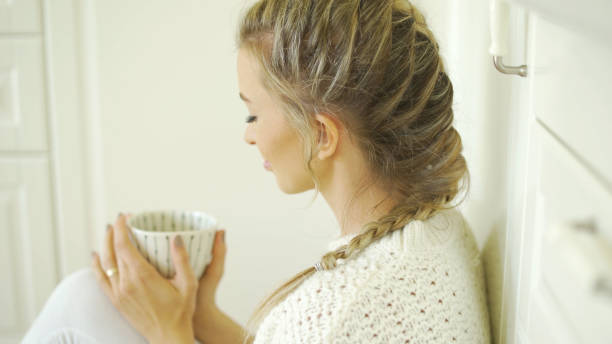 istock Young attractive woman relaxing with tea at home. 1357893904