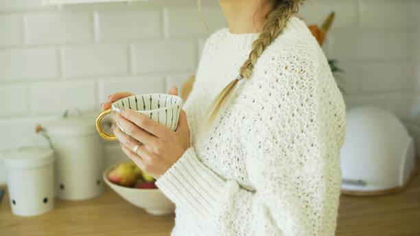 istock Young attractive woman relaxing with tea at home. 1357893941