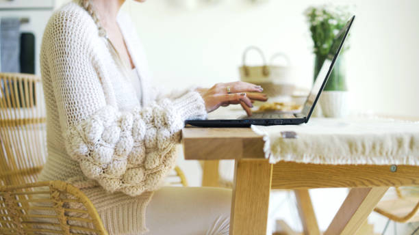 istock Young blonde woman working with computer at home. 1357894039