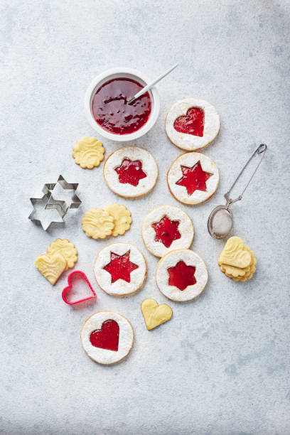 istock Classic Linzer Christmas Cookies with raspberry or strawberry jam on light background. 1357896162