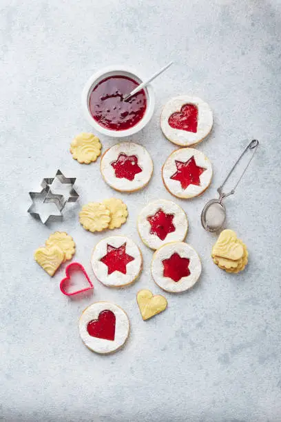 Classic Linzer Christmas Cookies with raspberry or strawberry jam on light background. Top view