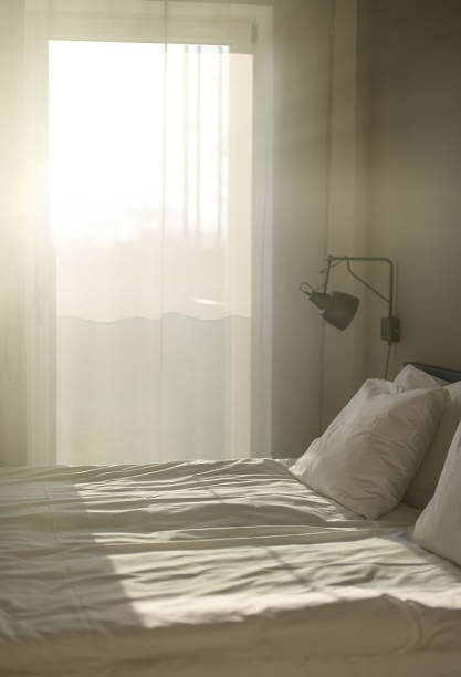 istock Bedroom is illuminated by the warm summer sun. 1357896249