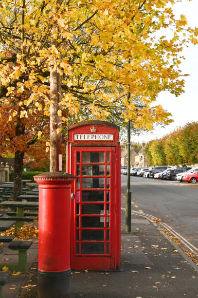 istock Phone booth and red post box in autumn 1357896468