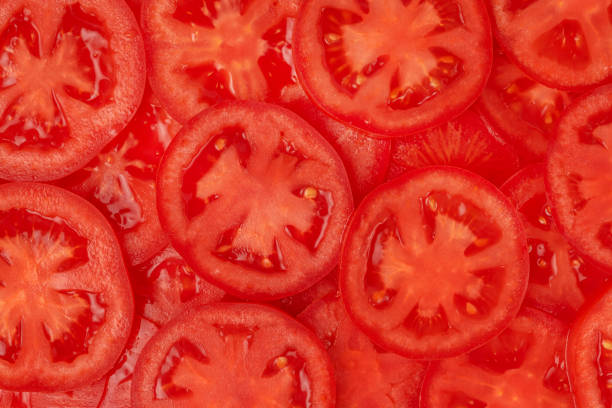 istock Pattern of sliced tomato, close up. 1357896670