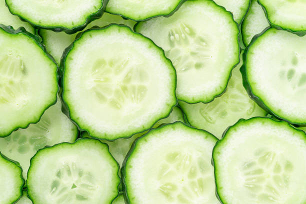 istock Pattern of sliced cucumber, close up, top view. 1357897615
