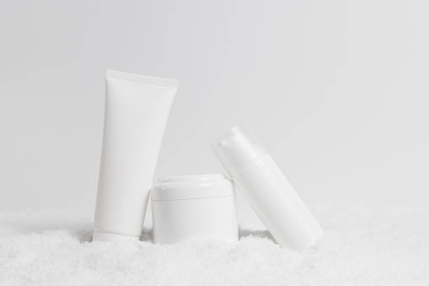 istock Care cosmetics blank bottles in snow 1357897691