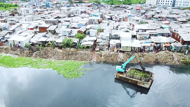 Drone view of slum houses on lakeside in Jakarta