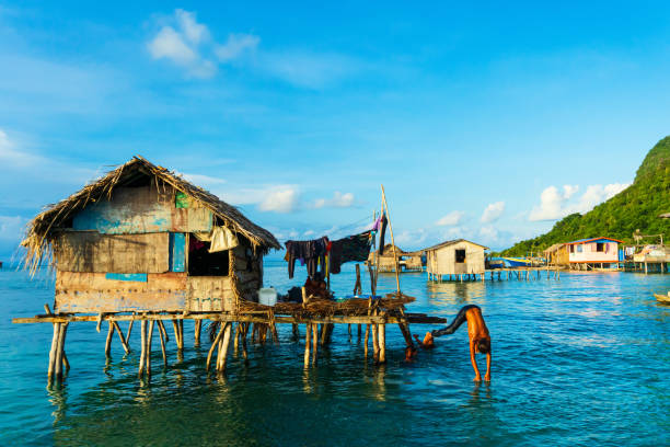 Water village inhabited by Sea Bajau or sea gypsy tribes in the waters of Semporna stock photo