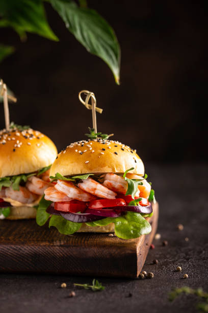 istock Delisious burger with shrimps on a wooden board 1357899373