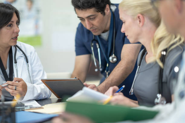istock Nurse sharing with a Medical Team 1357900536