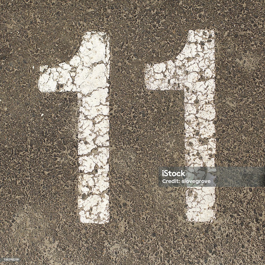 Carpark Number The number Eleven stencil painted in white on the ground of a  carpark Number 11 Stock Photo