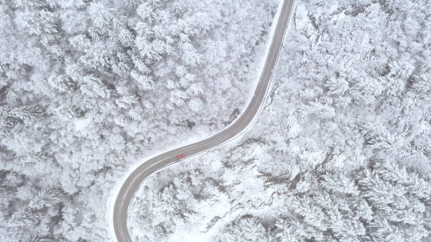 istock Car driving on winter country road 1357902370